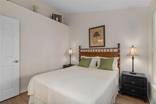 a bedroom with a bed and a night stand