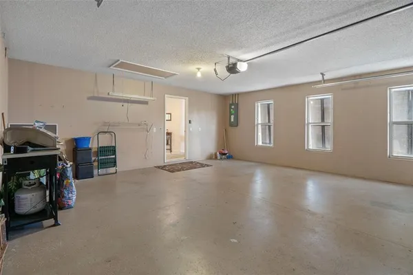 a view of a livingroom with fridge and workspace