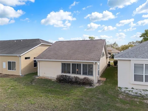a view of a house with a backyard