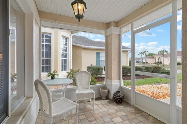 a dining room with furniture and a large window