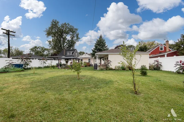 a view of a house with backyard sitting area and garden