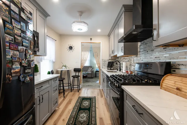 a kitchen with a stove a sink and a refrigerator