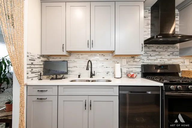 a kitchen with a sink stove and cabinets