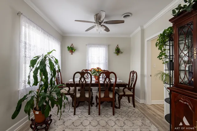 a view of a dining room with furniture and chandelier