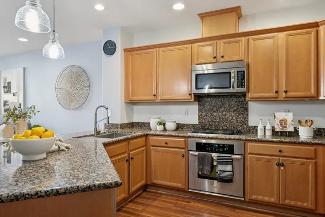a kitchen with stainless steel appliances and wooden cabinets