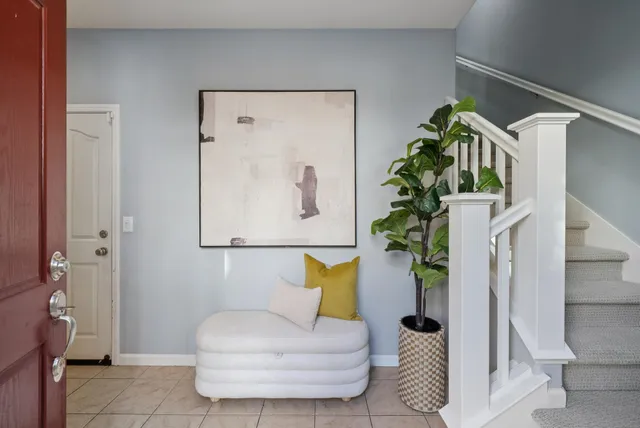 a living room with furniture and a potted plant