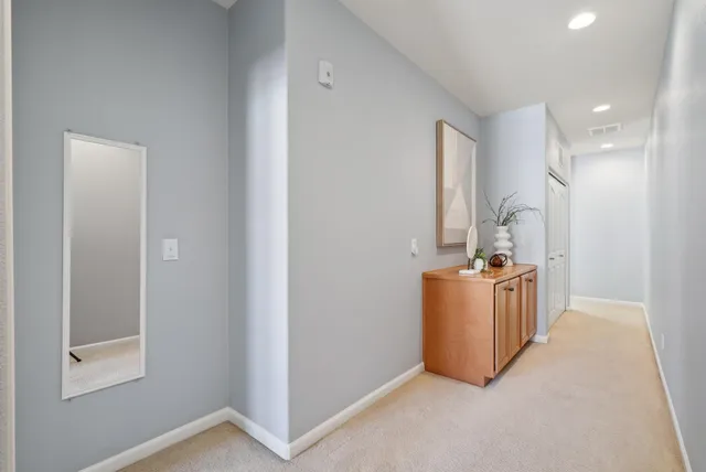 a bed room with a bed and a painting on the wall