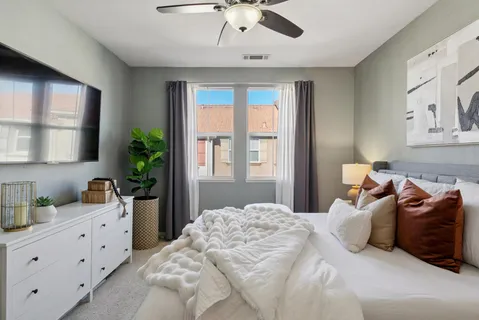 a bathroom with a double vanity sink a mirror and a bathtub