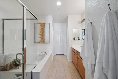 a en suite bathroom with a tub shower and sink