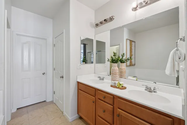 a spacious bathroom with a shower sink and mirror