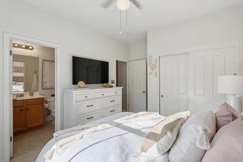 a bedroom with bed and a chandelier