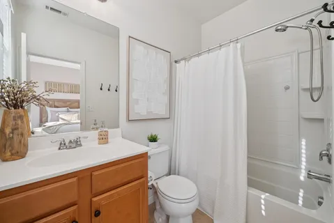 a bedroom with a bed and a flat tv screen on the dresser