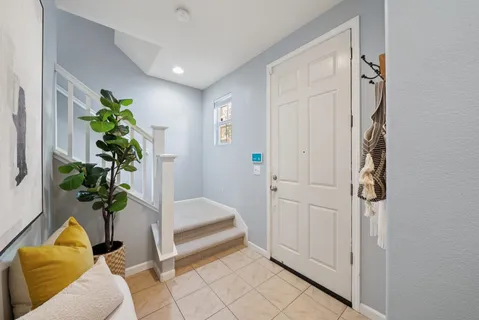 a living room with furniture and a potted plant