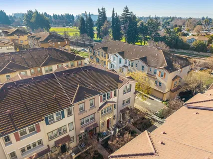a front view of a multi story building with yard