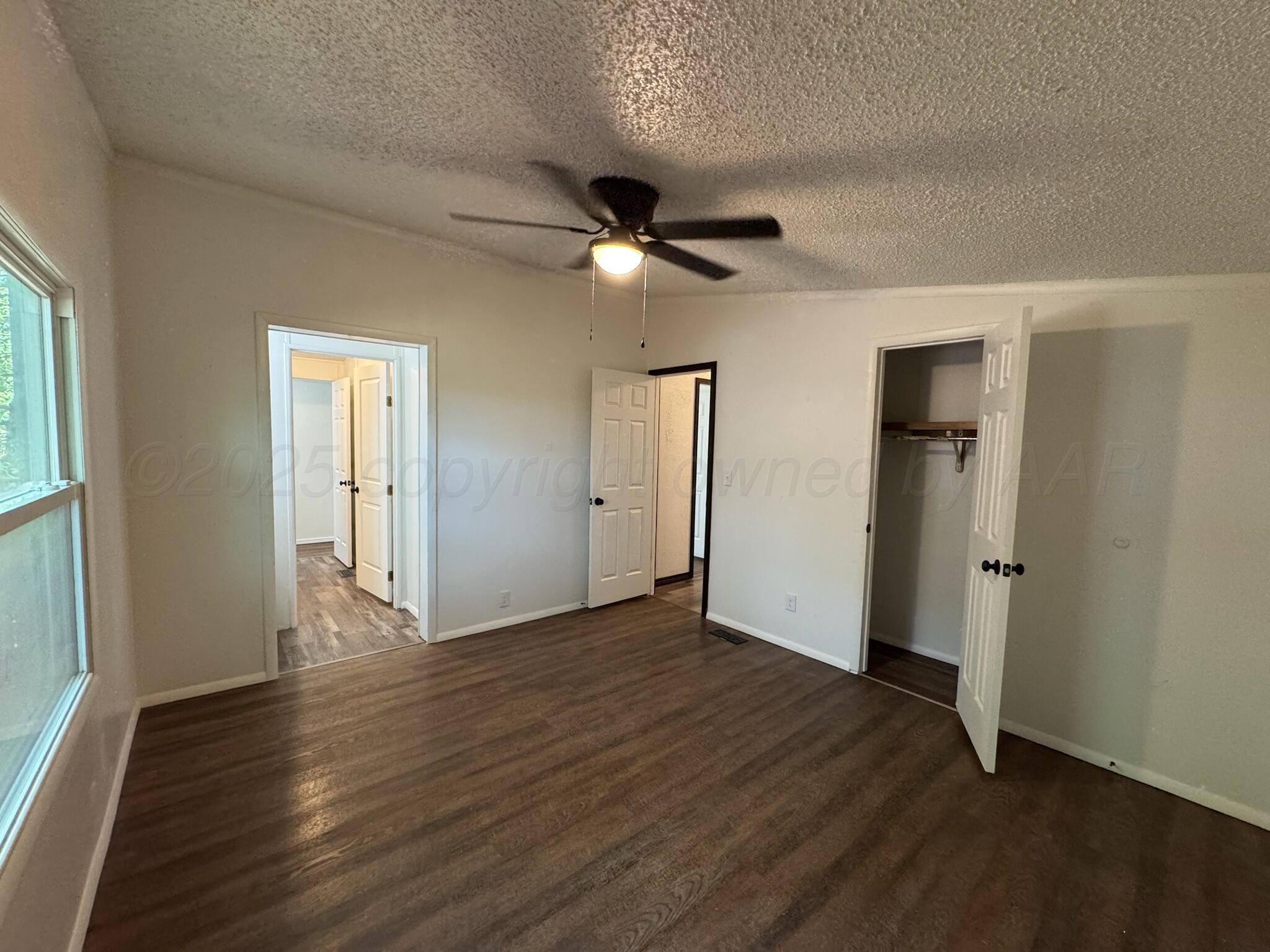 403 Aaron Road Fritch, TX 79036 - Photo 11 of 31 wooden floor in an empty room with a window