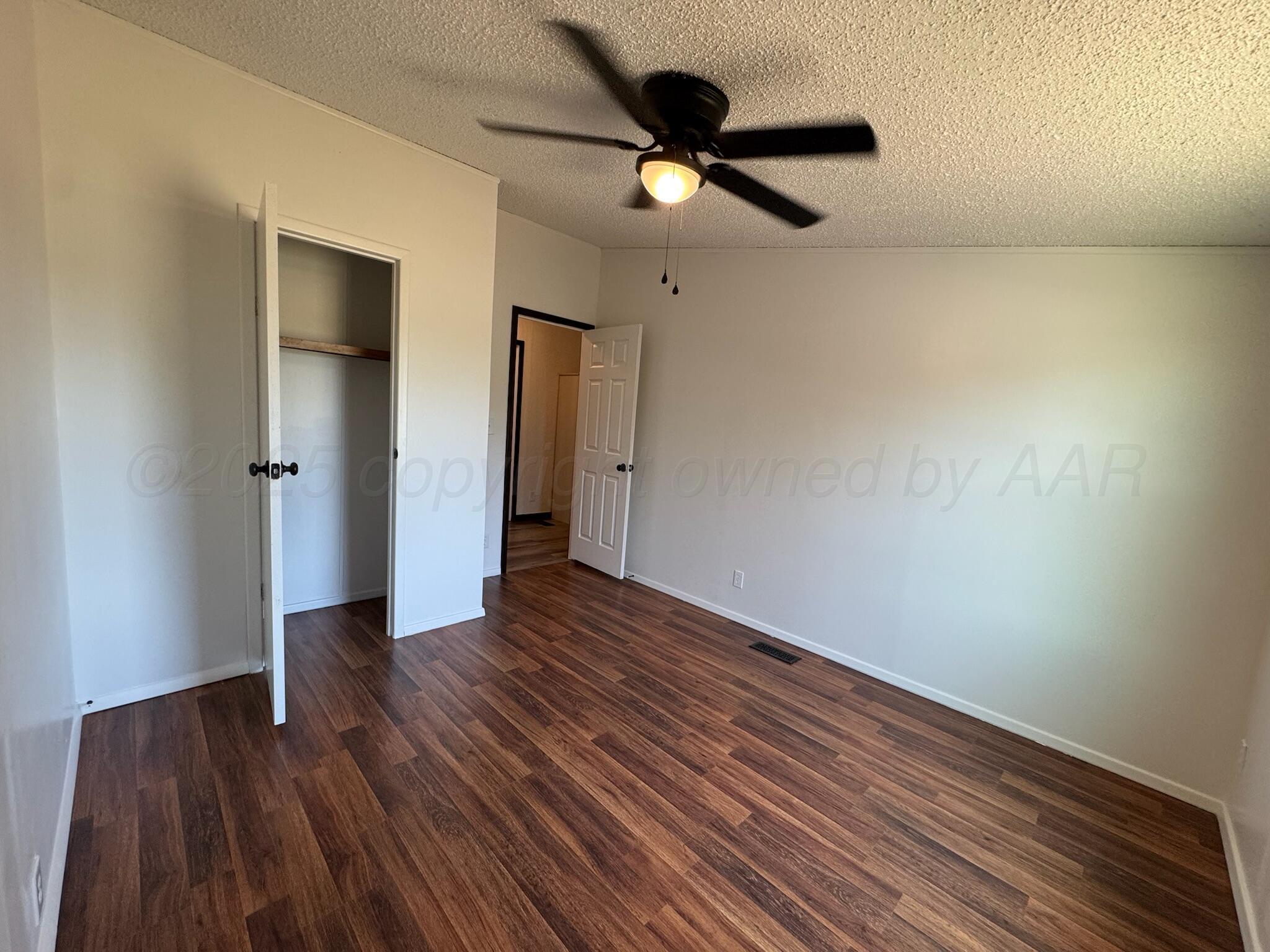 403 Aaron Road Fritch, TX 79036 - Photo 12 of 31 a view of an empty room with wooden floor