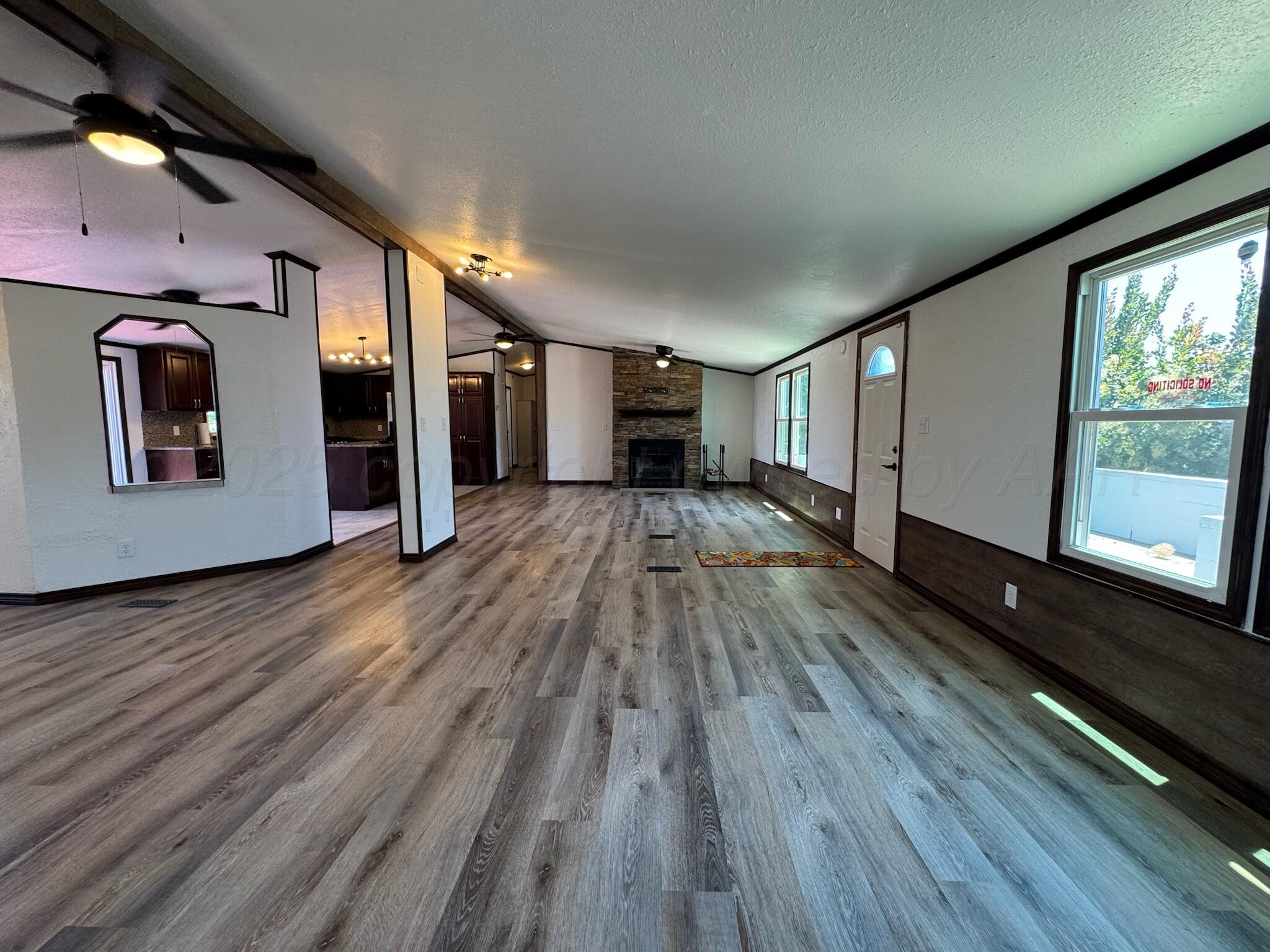 403 Aaron Road Fritch, TX 79036 - Photo 16 of 31 a view of a hallway with wooden floor
