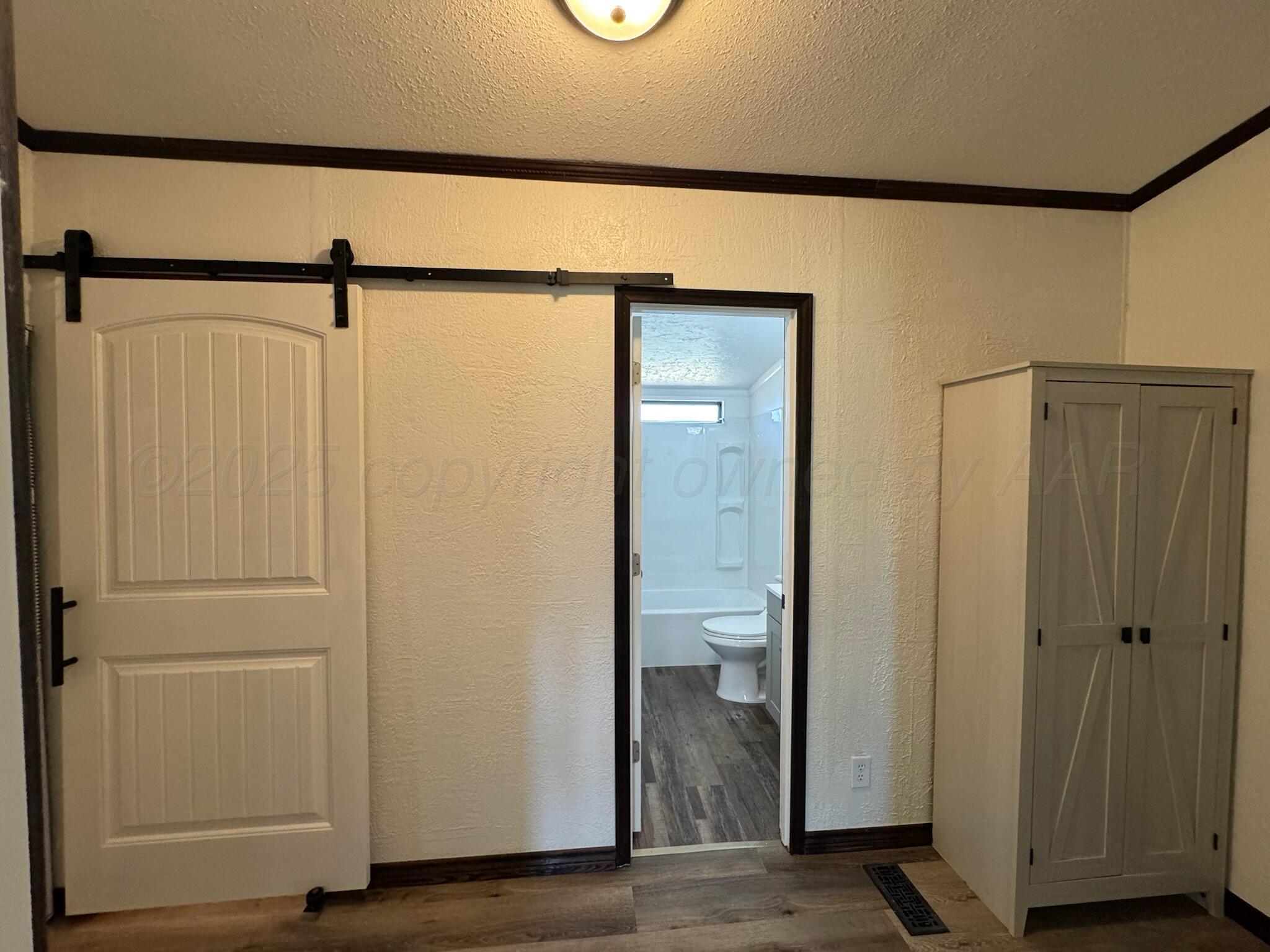 403 Aaron Road Fritch, TX 79036 - Photo 18 of 31 a view of a bathroom with a glass door