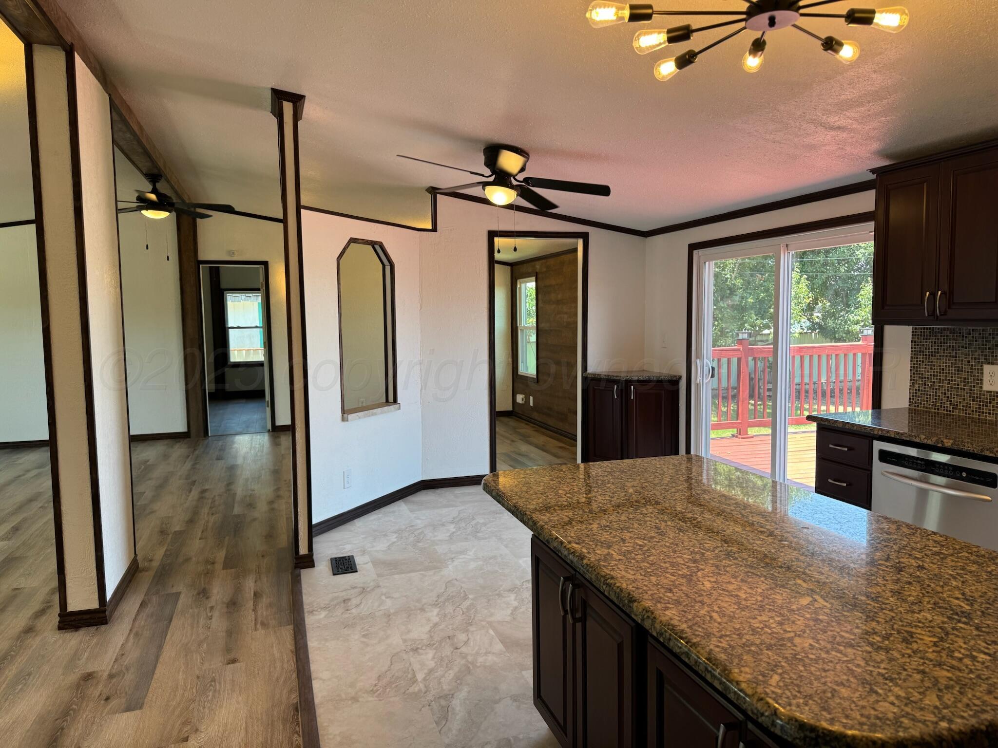 403 Aaron Road Fritch, TX 79036 - Photo 3 of 31 a kitchen with stainless steel appliances granite countertop a sink a refrigerator and wooden cabinets