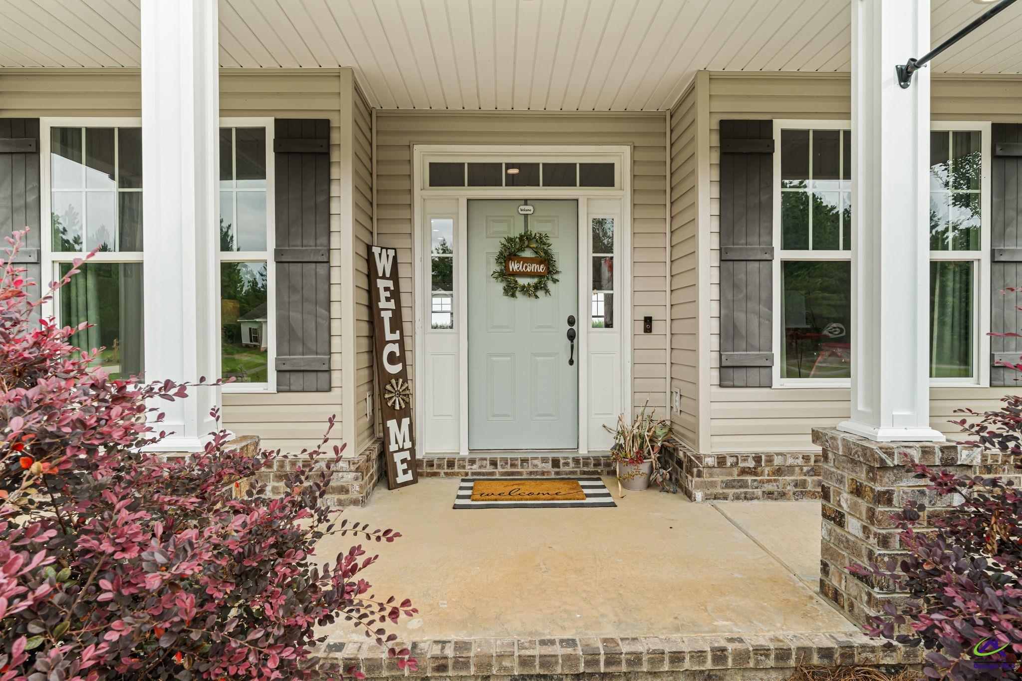 180 Woodland Trail Road Cochran, GA 31014 - Photo 3 of 25 front view of a house with a potted plant