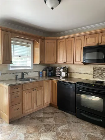 a kitchen with granite countertop a stove cabinets and a sink