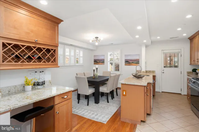 a kitchen with stainless steel appliances granite countertop a sink and a refrigerator