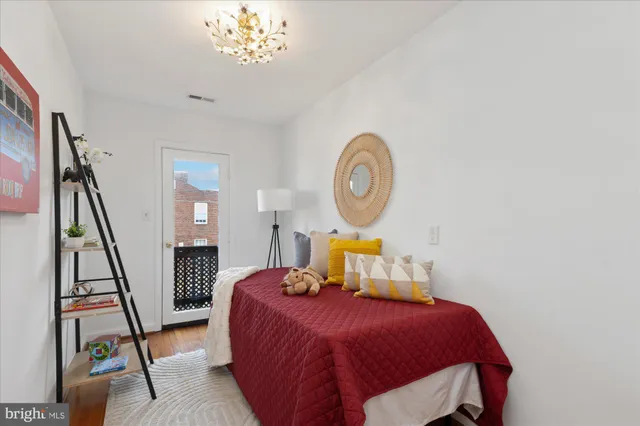 a bedroom with a bed and a chandelier