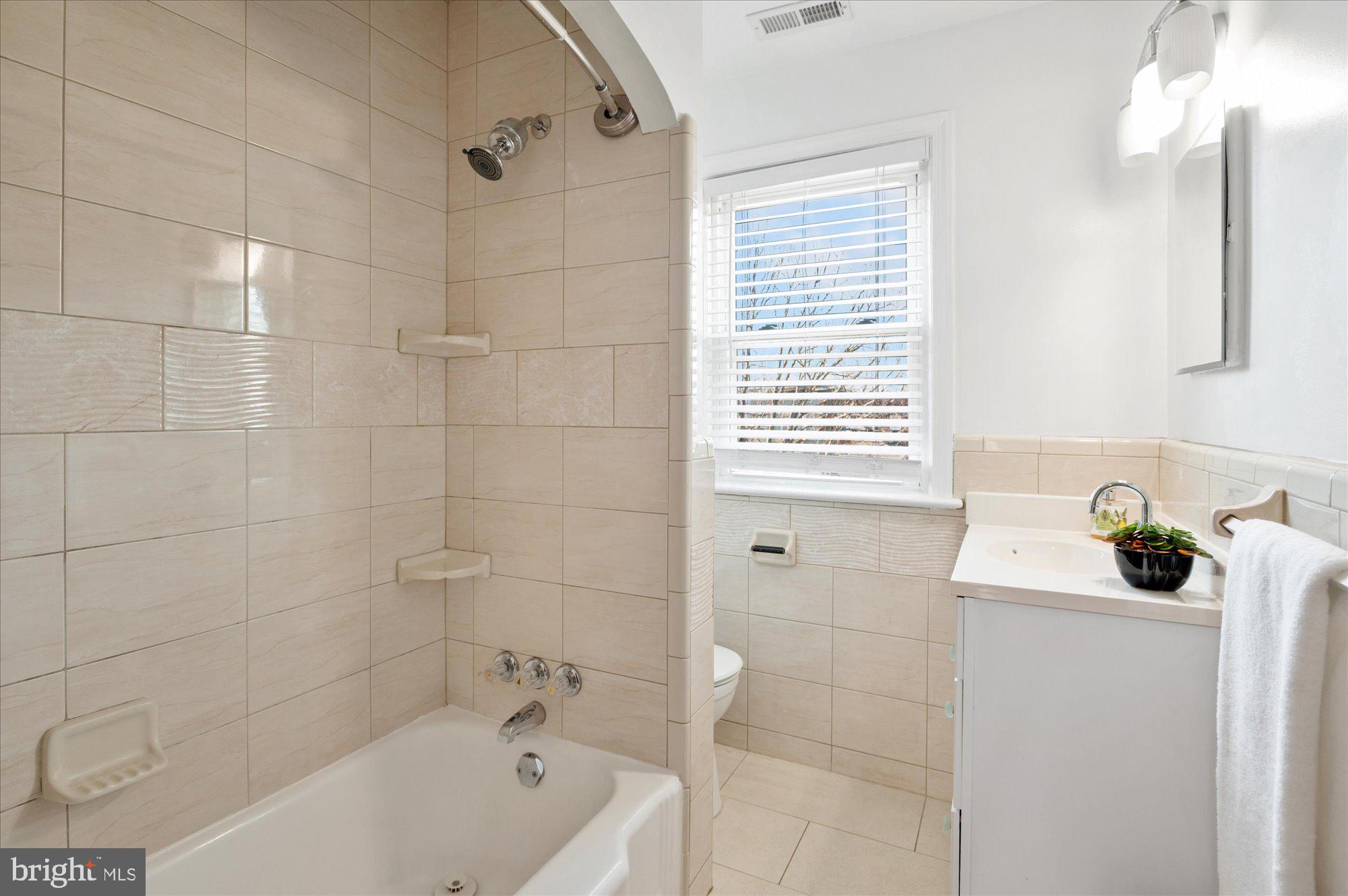 5049 North Capitol Street Northeast Washington, DC 20011 - Photo 10 of 20 a bathroom with a bathtub a sink and a shower