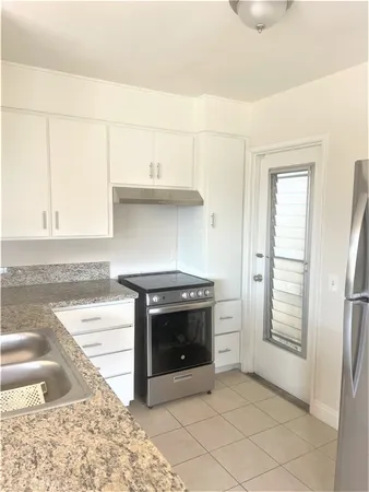 a kitchen with stainless steel appliances granite countertop a stove and a sink