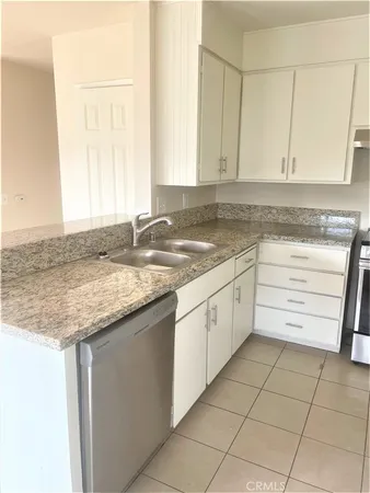a kitchen with granite countertop cabinets and window