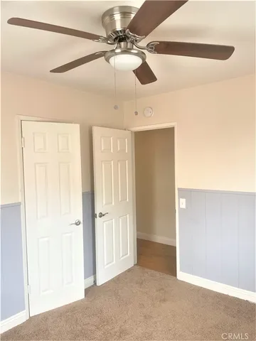 a view of a livingroom with a ceiling fan and window