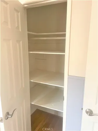 a view of walk in closet with empty racks