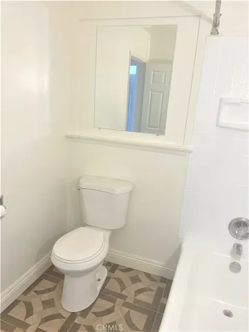 a white toilet sitting next to a white sink