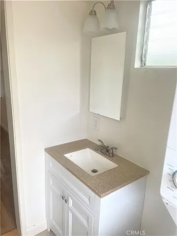 a bathroom with a sink a vanity and a mirror