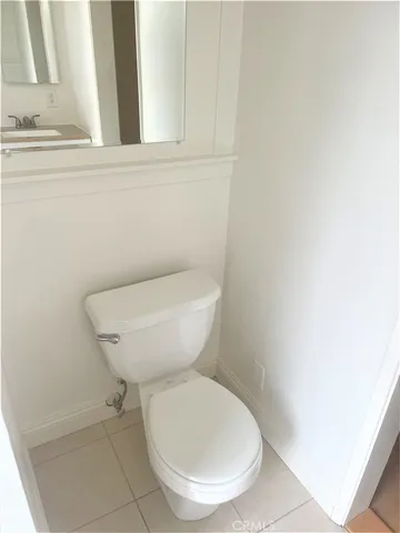 a bathroom with a toilet and a mirror