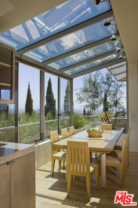 1827 Westridge Road Los Angeles, CA 90049 - Photo 11 of 34 a view of a patio with a backyard table and chairs