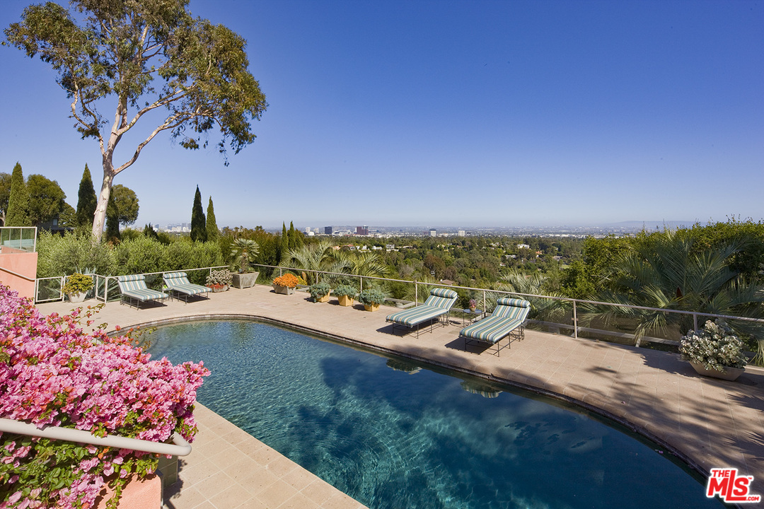 1827 Westridge Road Los Angeles, CA 90049 - Photo 15 of 34 a view of a swimming pool with a patio