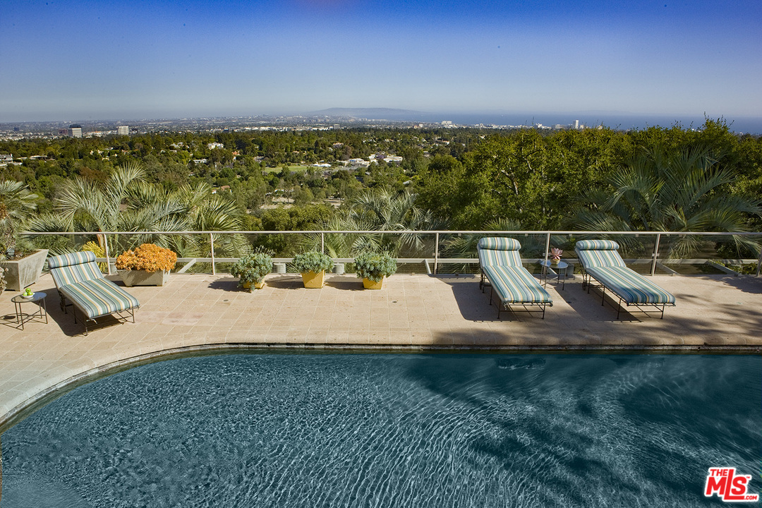 1827 Westridge Road Los Angeles, CA 90049 - Photo 16 of 34 a view of a swimming pool with a yard