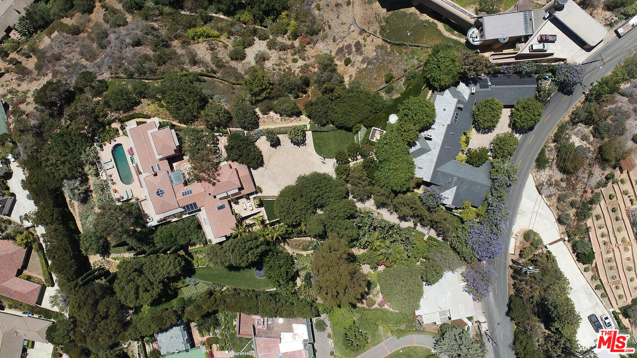 1827 Westridge Road Los Angeles, CA 90049 - Photo 3 of 34 an aerial view of a house with a yard and large trees