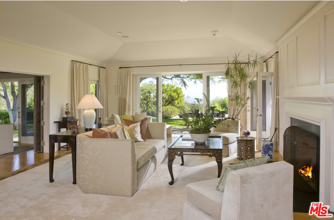1827 Westridge Road Los Angeles, CA 90049 - Photo 27 of 34 a living room with fireplace furniture and a large window