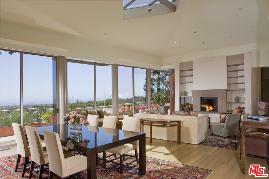 1827 Westridge Road Los Angeles, CA 90049 - Photo 8 of 34 a room with lots of tables a large window and chairs