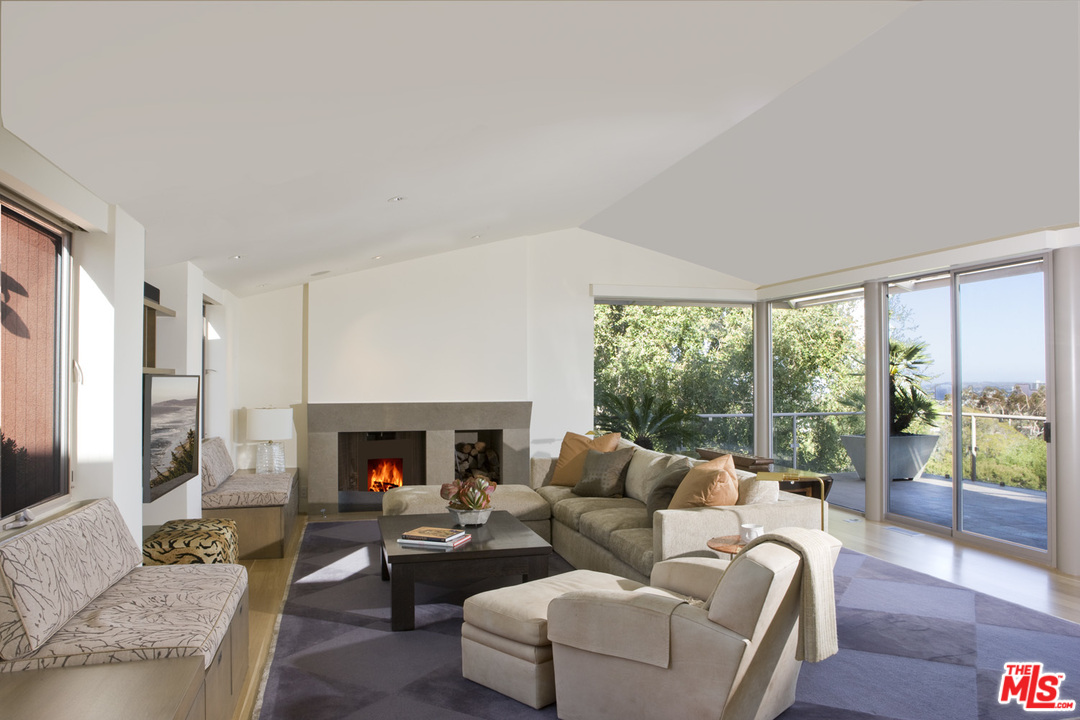1827 Westridge Road Los Angeles, CA 90049 - Photo 10 of 34 a living room with furniture fireplace and a large window