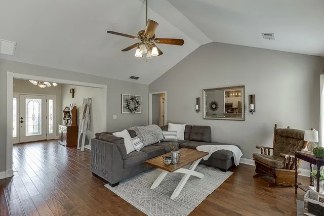 a living room with furniture and wooden floor