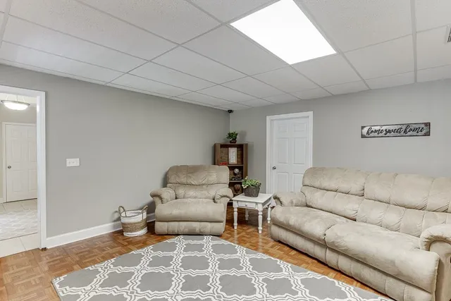 a living room with furniture a window and a fireplace