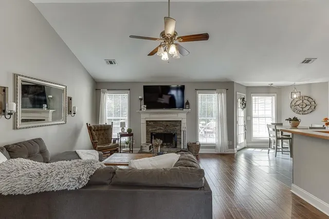 a living room with furniture and a fireplace