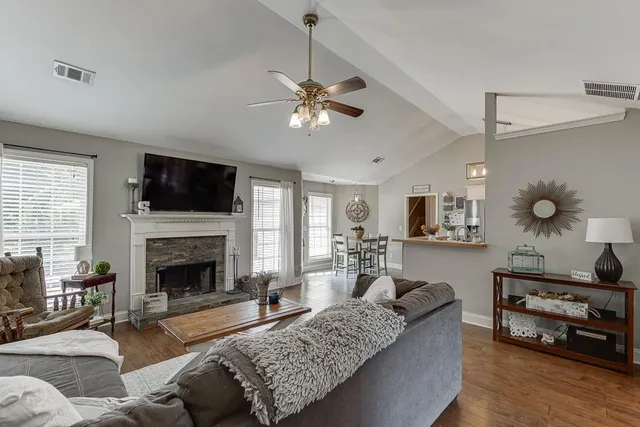 a living room with furniture and a fireplace