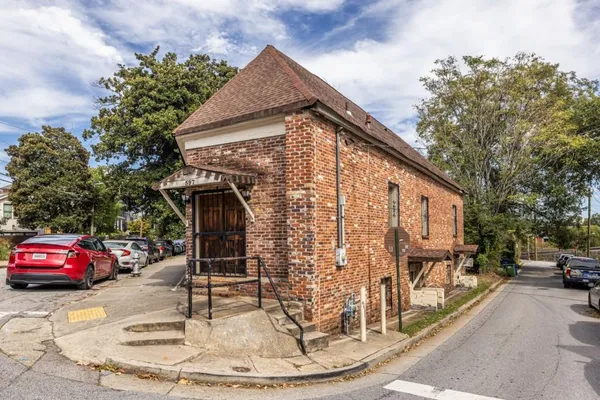 a view of a brick house with street