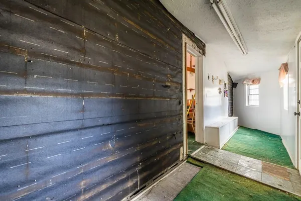 a view of an entryway with wooden floor and a window