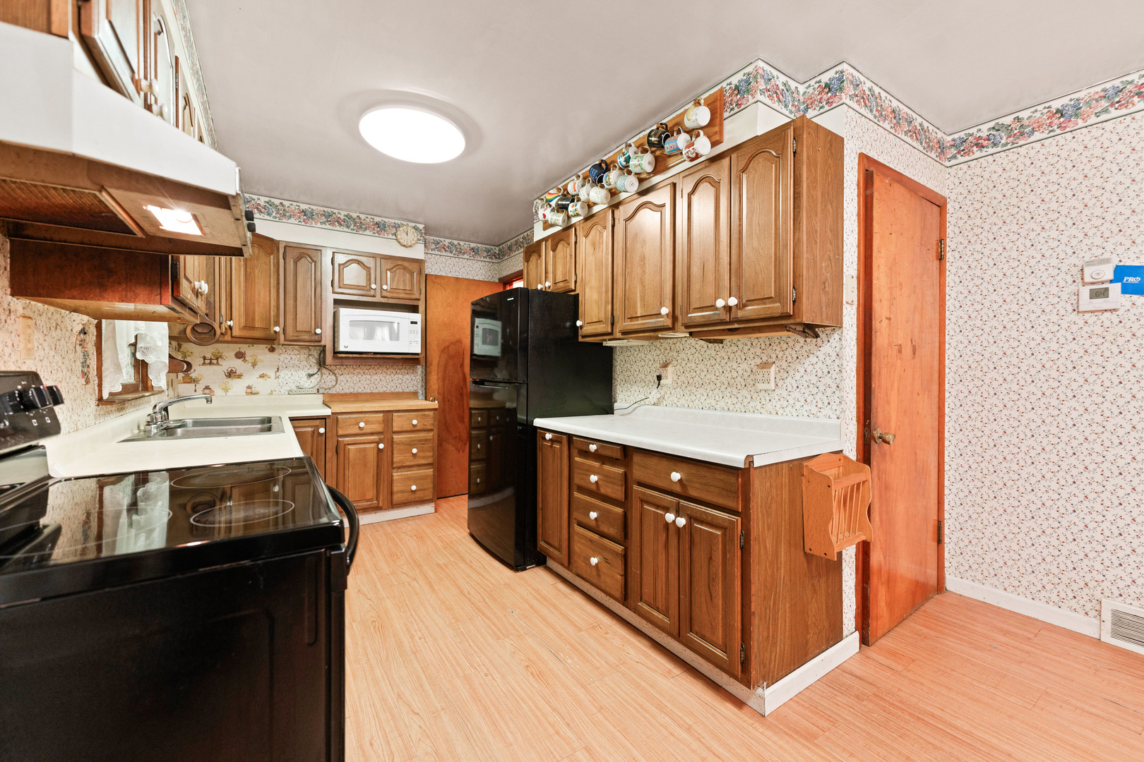 50W762 Ramm Road Maple Park, IL 60151 - Photo 14 of 37 a kitchen with stainless steel appliances granite countertop a sink a stove and a refrigerator