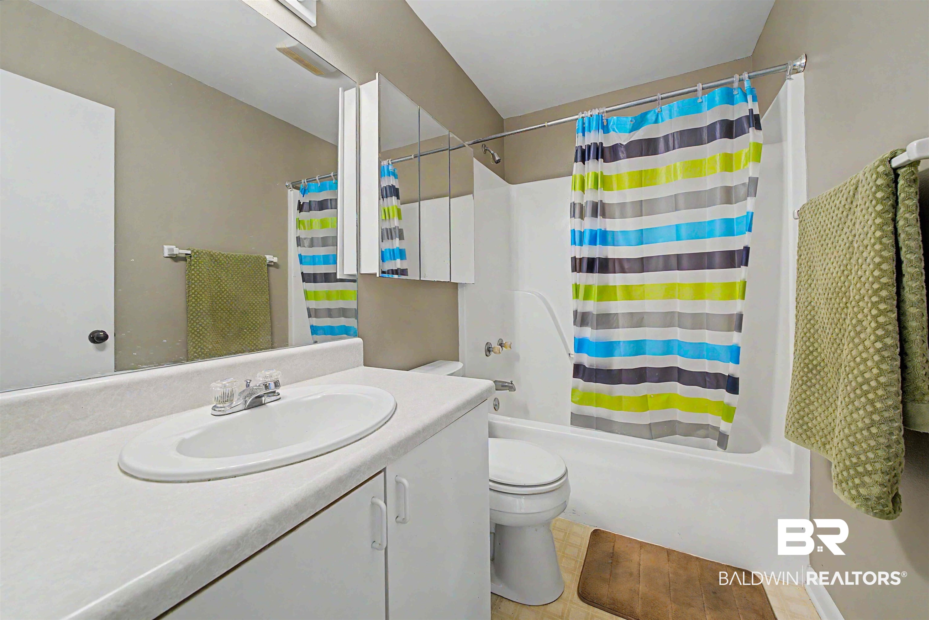 22963 Highway 98 Foley, AL 36535 - Photo 28 of 52 Bathroom featuring a white vanity with integrated sink, white cabinetry, and a mirrored medicine cabinet